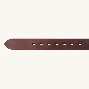 Close-up of a brown leather work belt with evenly spaced rectangular holes along its length on a light background.